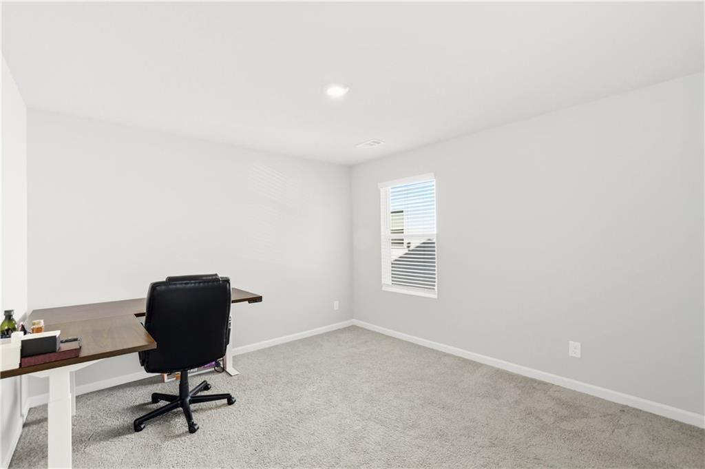 7626 Jennadee Drive Fairburn, GA 30213 - Photo 20 of 27 a view of a workspace with furniture and a window