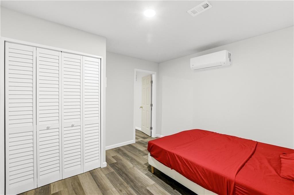 7626 Jennadee Drive Fairburn, GA 30213 - Photo 24 of 27 a room with a bed and a potted plant