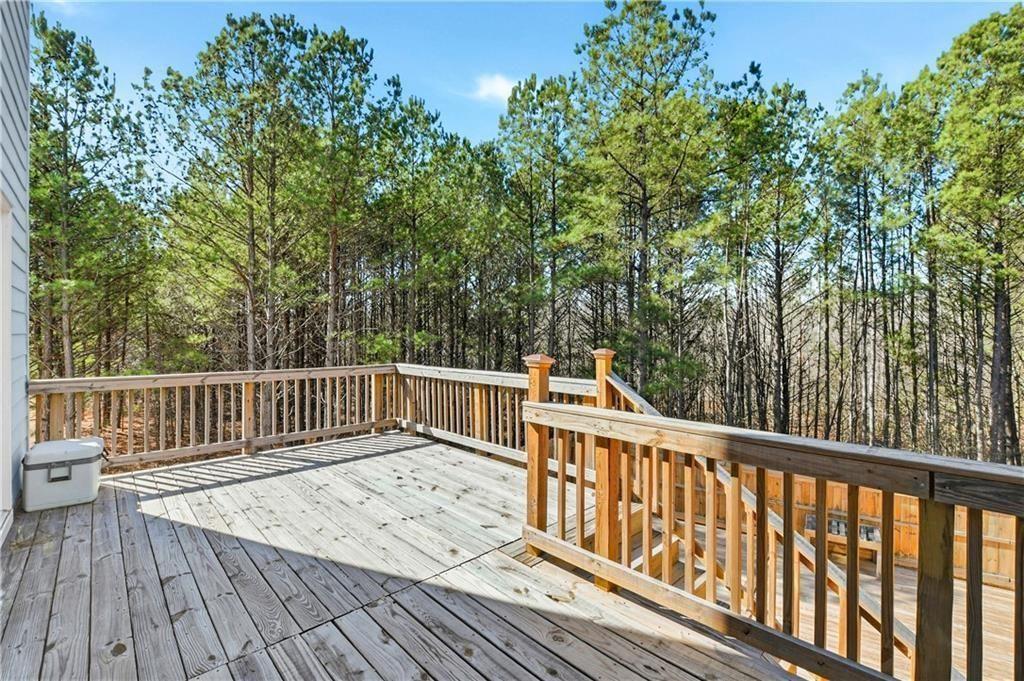 7626 Jennadee Drive Fairburn, GA 30213 - Photo 25 of 27 a view of balcony with wooden floor and fence