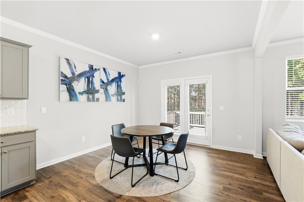 7626 Jennadee Drive Fairburn, GA 30213 - Photo 10 of 27 a view of a dining room with furniture window and wooden floor