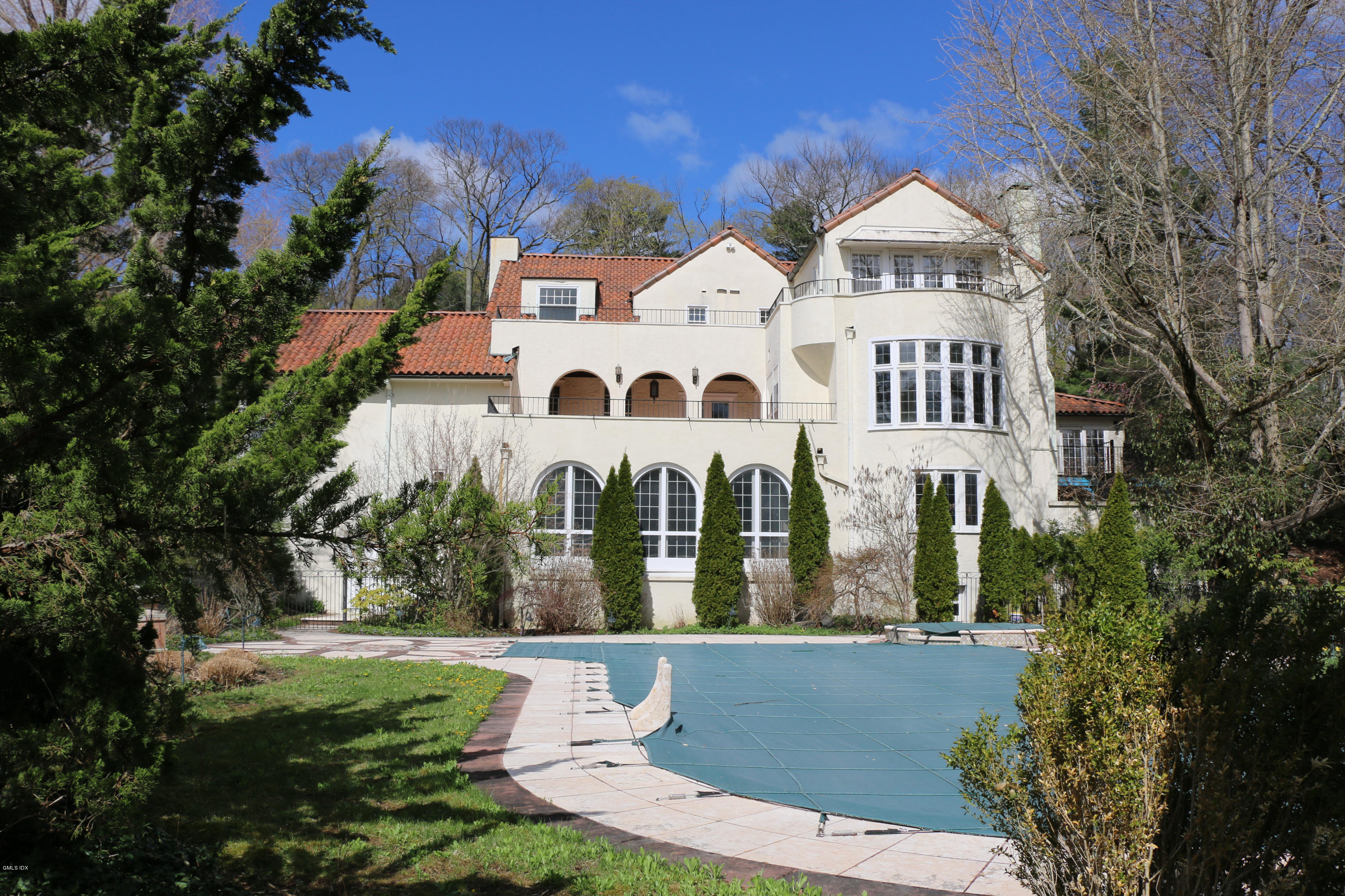 39 Doubling Road Greenwich, CT 06830 - Photo 1 of 1 a view of a white house with a yard and potted plants
