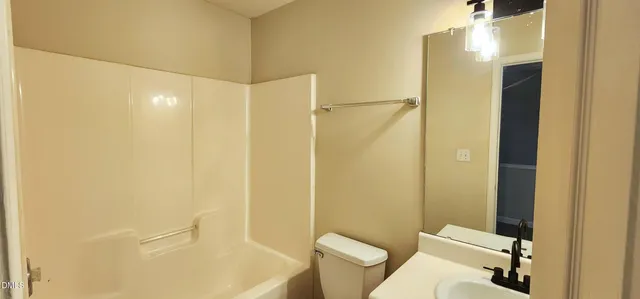 a bathroom with a shower and a toilet