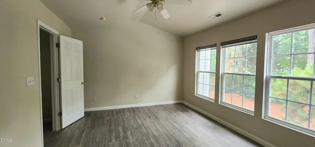 a view of a room with wooden floor and windows