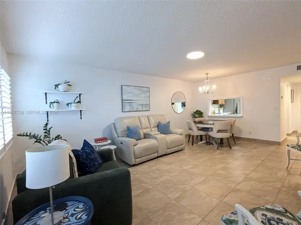 a living room with furniture and a lamp