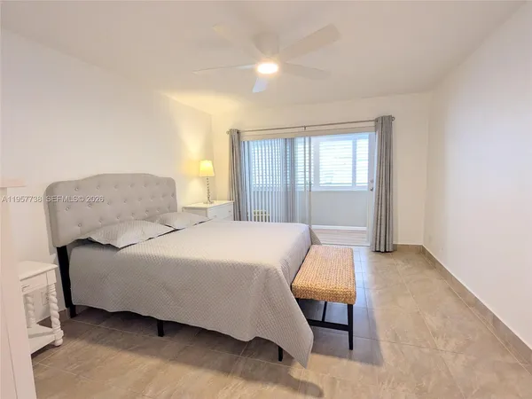 a bedroom with a bed and chair