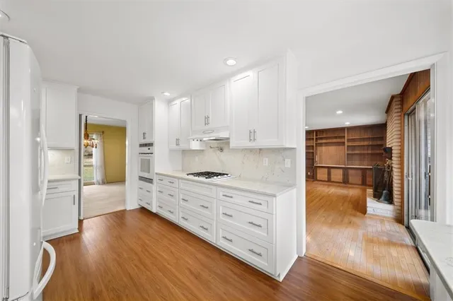 a large kitchen with kitchen island a sink stainless steel appliances and cabinets
