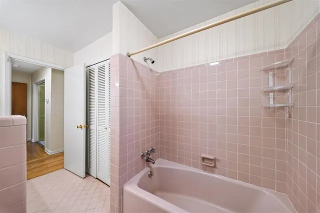 a bathroom with a bathtub and a shower