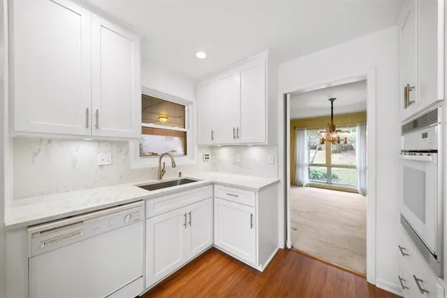 a kitchen with a sink cabinets and wooden floor