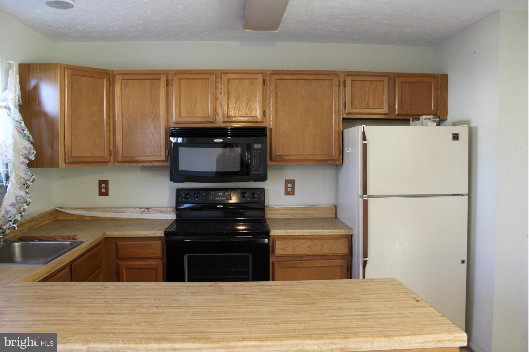 358 Rambling Ridge Court Pasadena, MD 21122 - Photo 3 of 6 a kitchen with a refrigerator and a sink