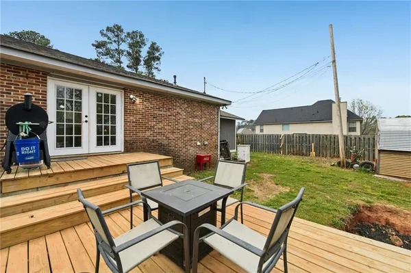 a view of a patio with table and chairs and potted plants