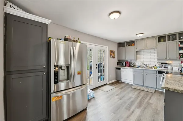 a kitchen with stainless steel appliances a refrigerator and a stove top oven