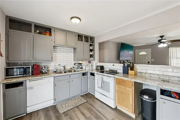 a kitchen with a sink a stove and cabinets