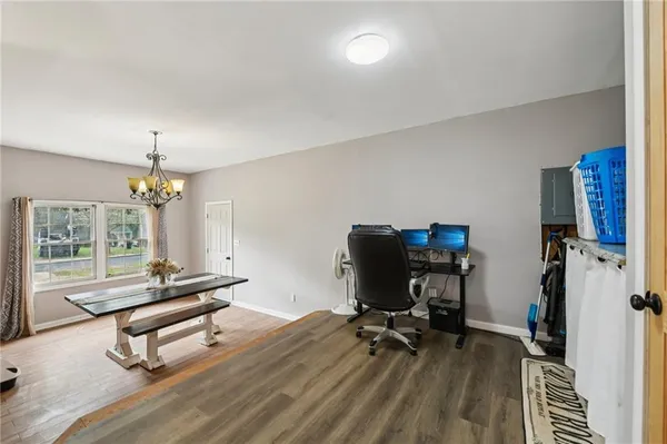 a view of a workspace with furniture and a window