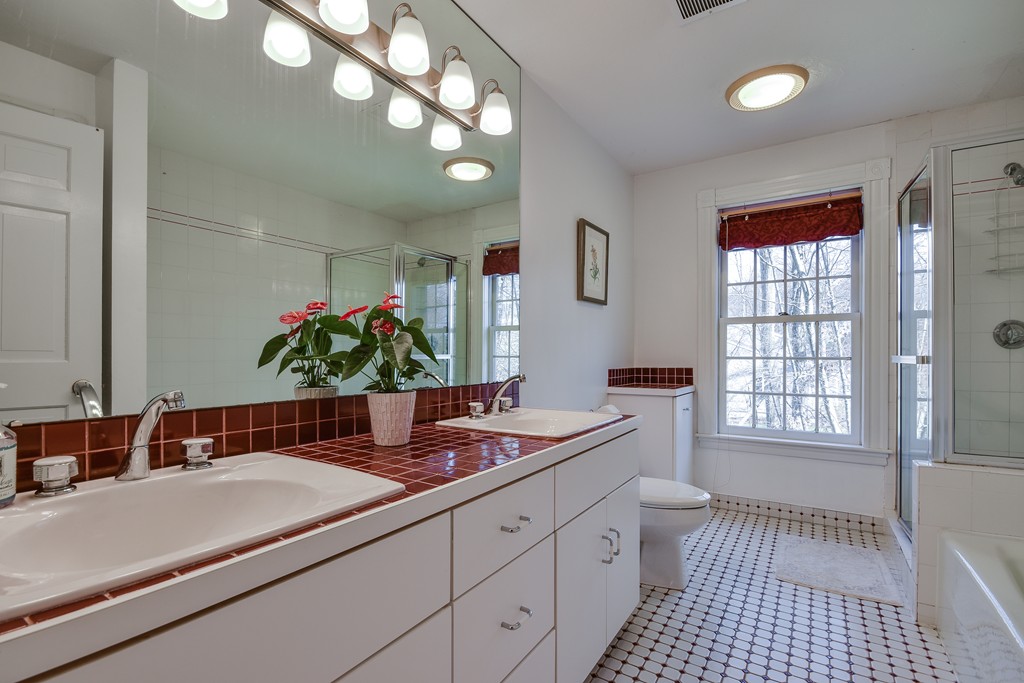 929 Salem End Road Framingham, MA 01702 - Photo 23 of 29 a bathroom with a sink a vanity and a mirror