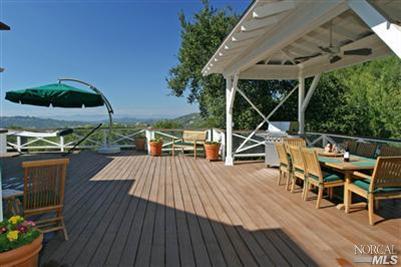 1820 Calistoga Road Santa Rosa, CA 95404 - Photo 10 of 12 a view of a roof deck with table and chairs a barbeque with wooden floor and fence