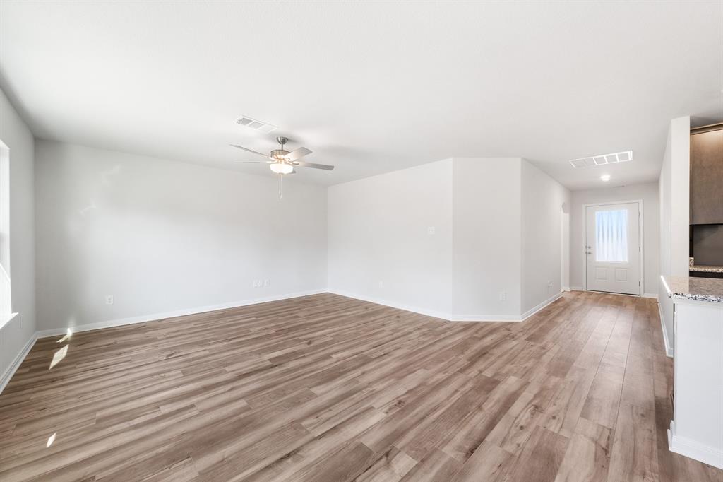 6311 Racer Smt Drive Dallas, TX 75241 - Photo 10 of 18 a view of kitchen and empty room with wooden floor
