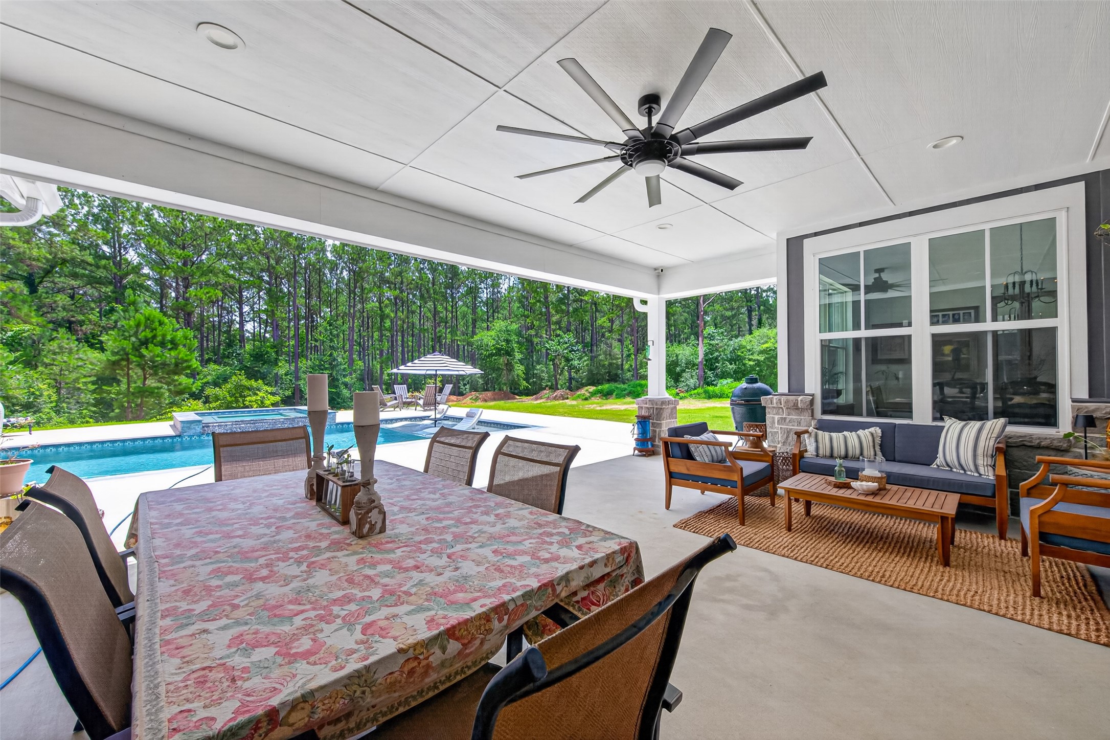 10915 Ruger Road Willis, TX 77378 - Photo 43 of 50 This inviting outdoor porch offers ample space for lounging, dining, or unwinding to the soothing sound of a spa waterfall, creating the perfect relaxation retreat.