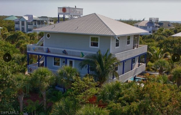 an aerial view of a house with balcony and trees al around