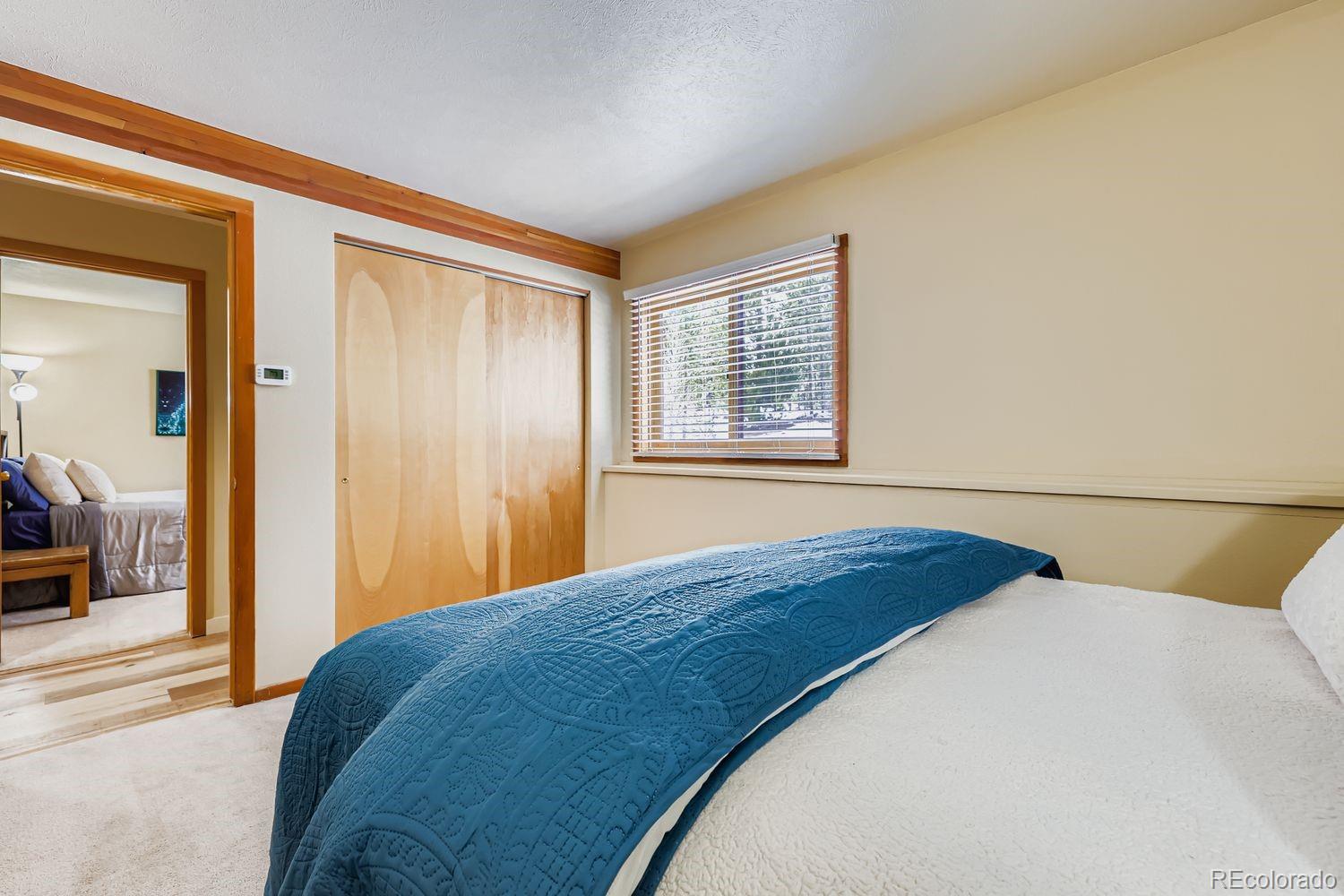 91300 Ryan Gulch Road, Unit 91305 Silverthorne, CO 80498 - Photo 14 of 40 a bedroom with a bed and a window