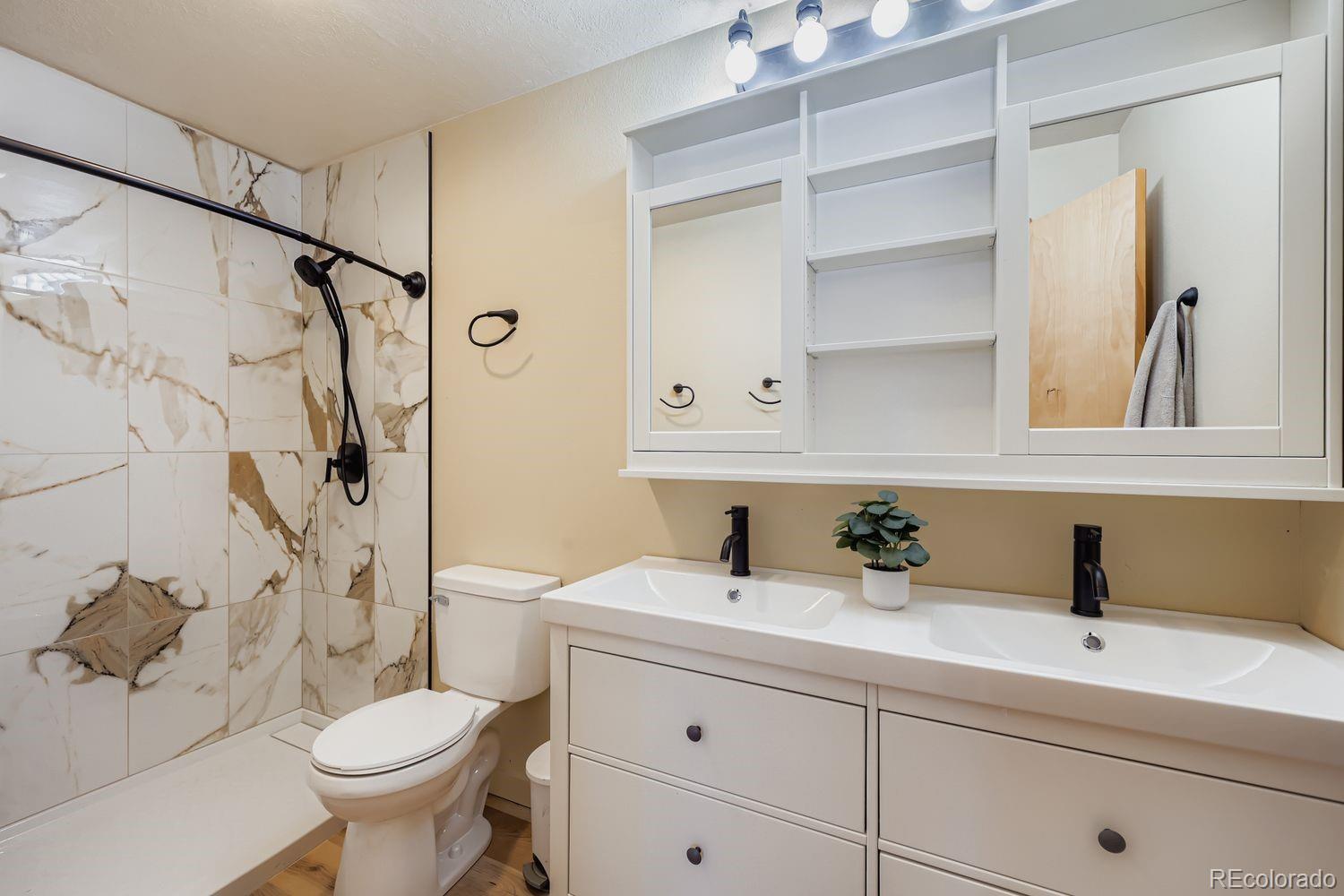 91300 Ryan Gulch Road, Unit 91305 Silverthorne, CO 80498 - Photo 15 of 40 a bathroom with a sink a toilet and shower