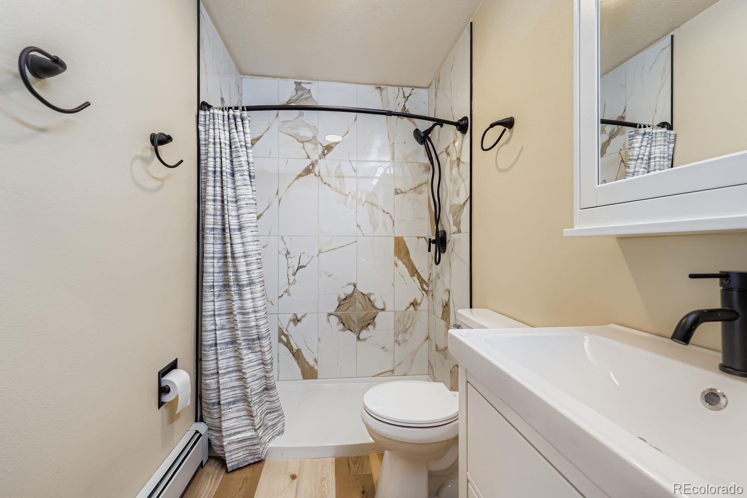 91300 Ryan Gulch Road, Unit 91305 Silverthorne, CO 80498 - Photo 16 of 40 a bathroom with a sink toilet and shower