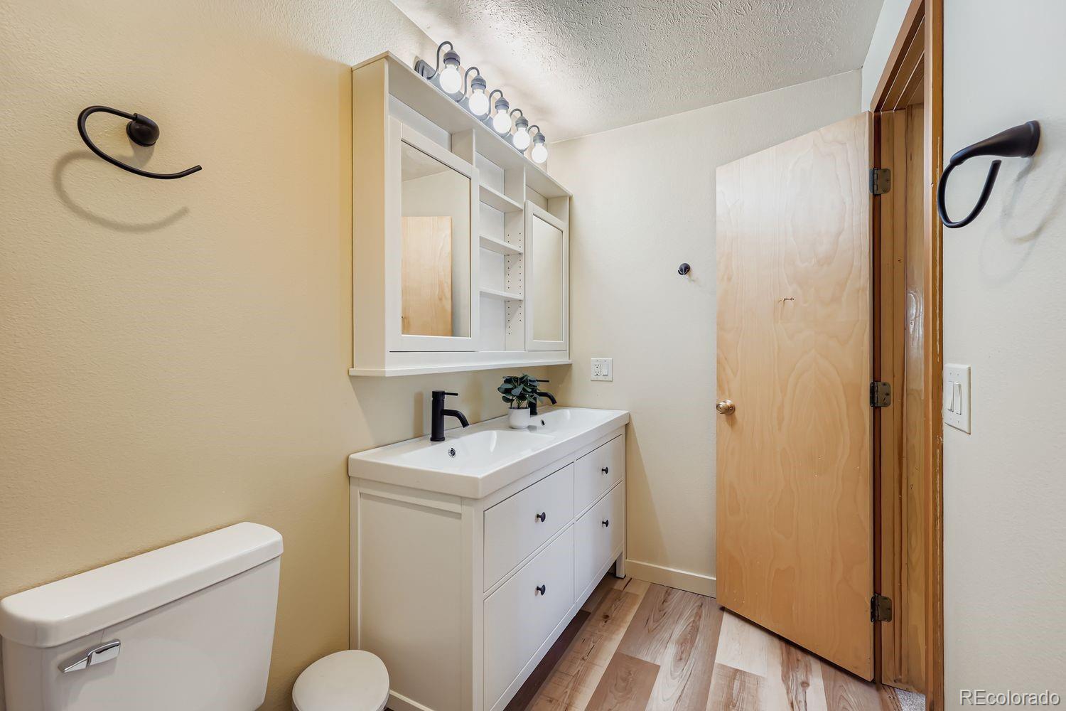 91300 Ryan Gulch Road, Unit 91305 Silverthorne, CO 80498 - Photo 17 of 40 a bathroom with a sink a toilet and shower
