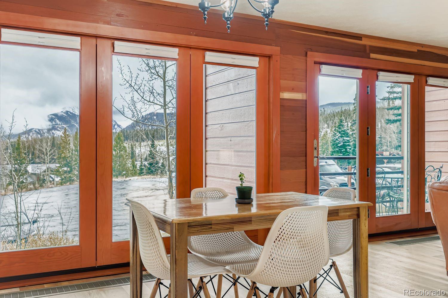 91300 Ryan Gulch Road, Unit 91305 Silverthorne, CO 80498 - Photo 2 of 40 a dining room with furniture and wooden floor