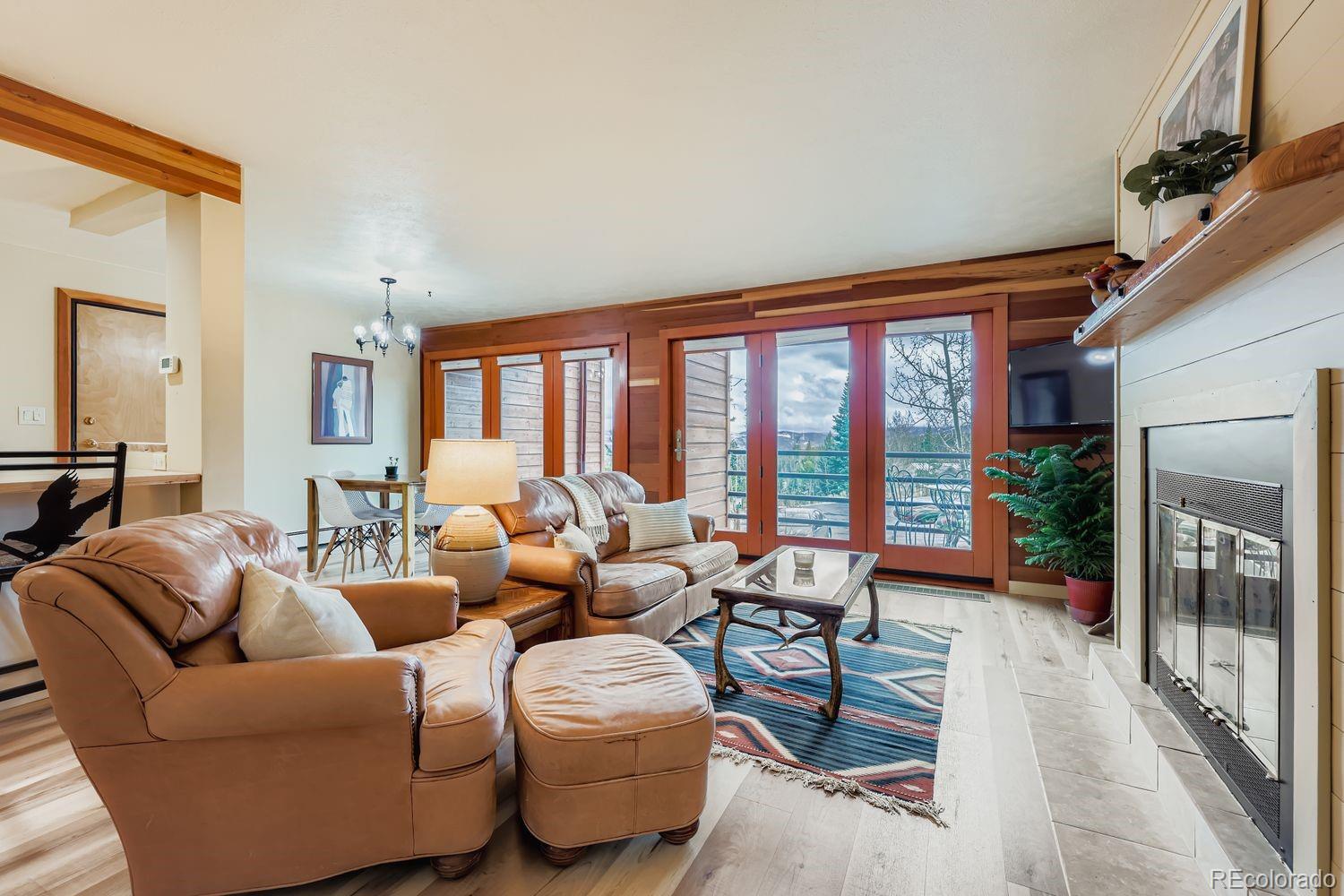 91300 Ryan Gulch Road, Unit 91305 Silverthorne, CO 80498 - Photo 9 of 40 a living room with furniture and a large window