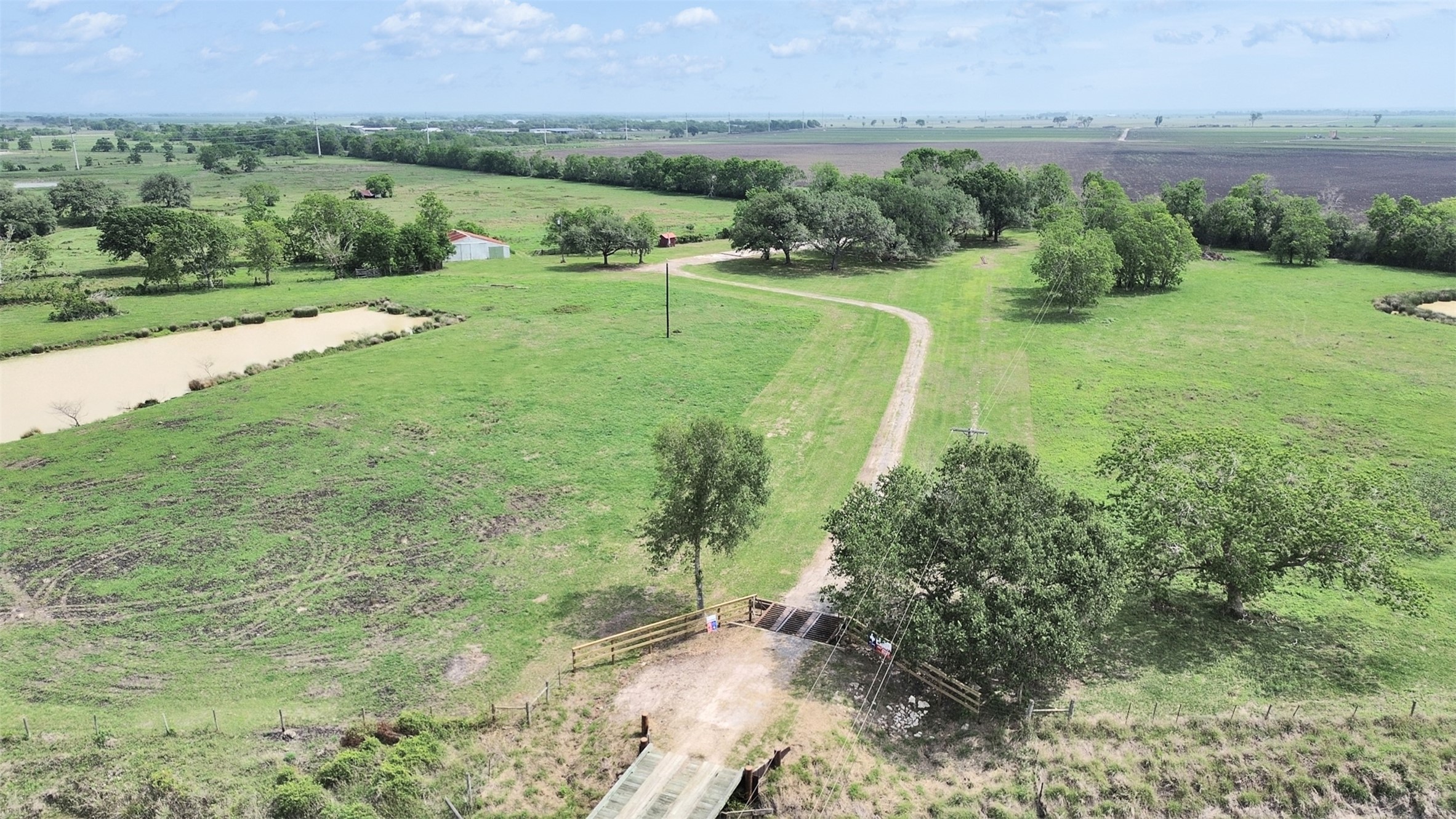 2100 Pine Knoll Road Bay City, TX 77414 - Photo 1 of 28 a view of a lush green forest with a lake view