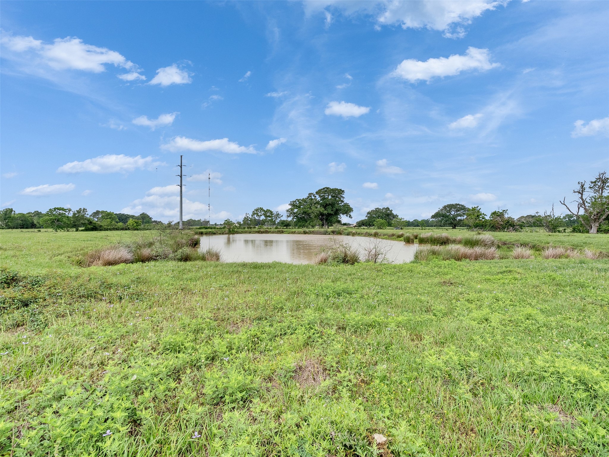 2100 Pine Knoll Road Bay City, TX 77414 - Photo 26 of 28 a view of a lake with houses in the back