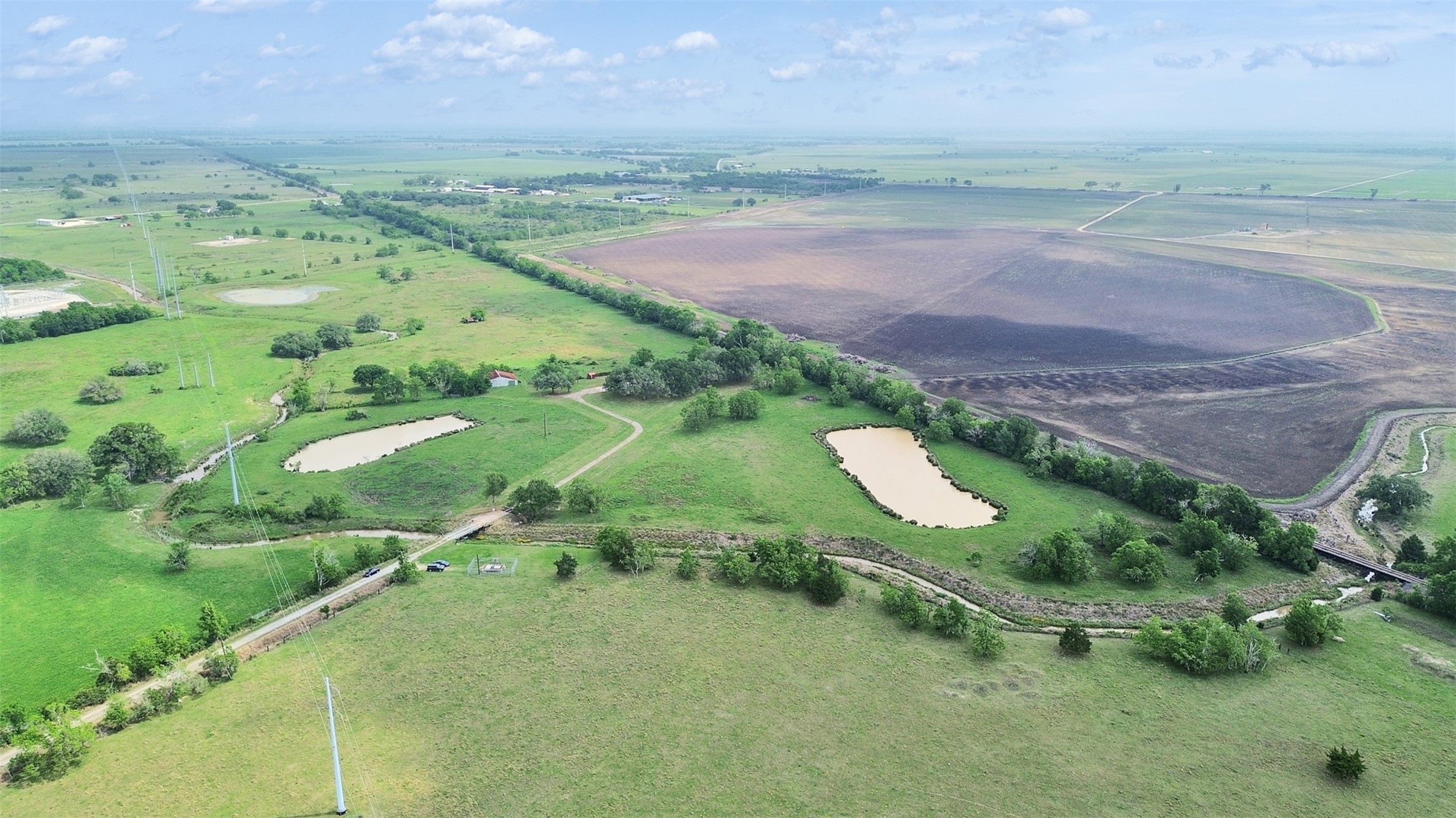 2100 Pine Knoll Road Bay City, TX 77414 - Photo 9 of 28 a backyard of a house with a yard and lake