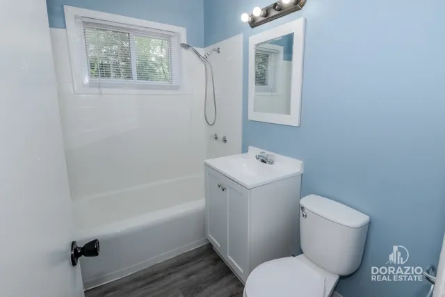 a bathroom with a toilet sink and mirror