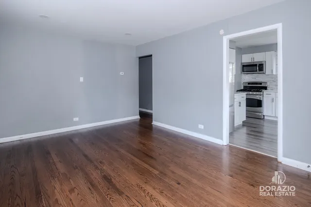a view of wooden floor and windows in a room