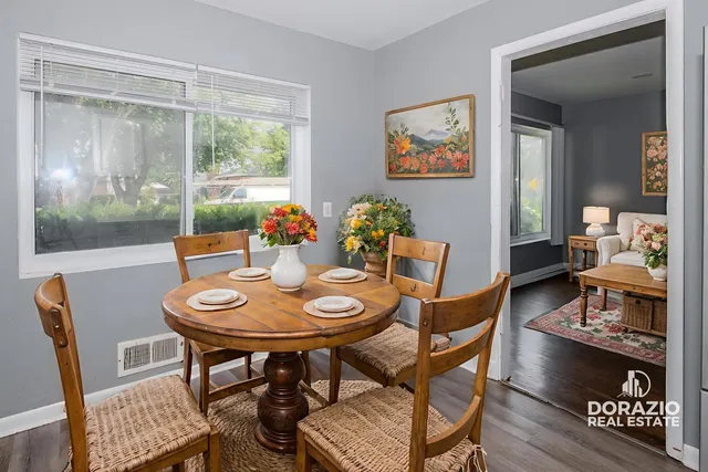 a dining room with furniture a rug and wooden floor