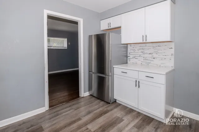 a kitchen with a refrigerator and cabinets
