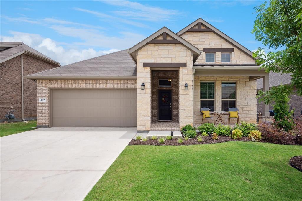 a front view of a house with a garden and plants