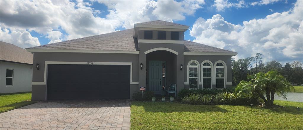 9032 Cape Cod Road DeLand, FL 32724 - Photo 1 of 16 a front view of a house with garden