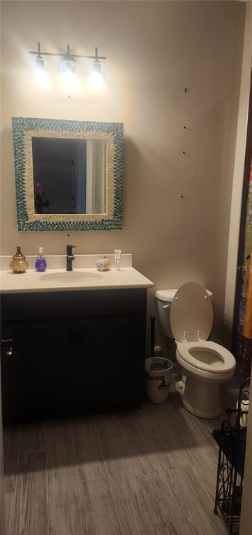 9032 Cape Cod Road DeLand, FL 32724 - Photo 12 of 16 a bathroom with a toilet sink and mirror