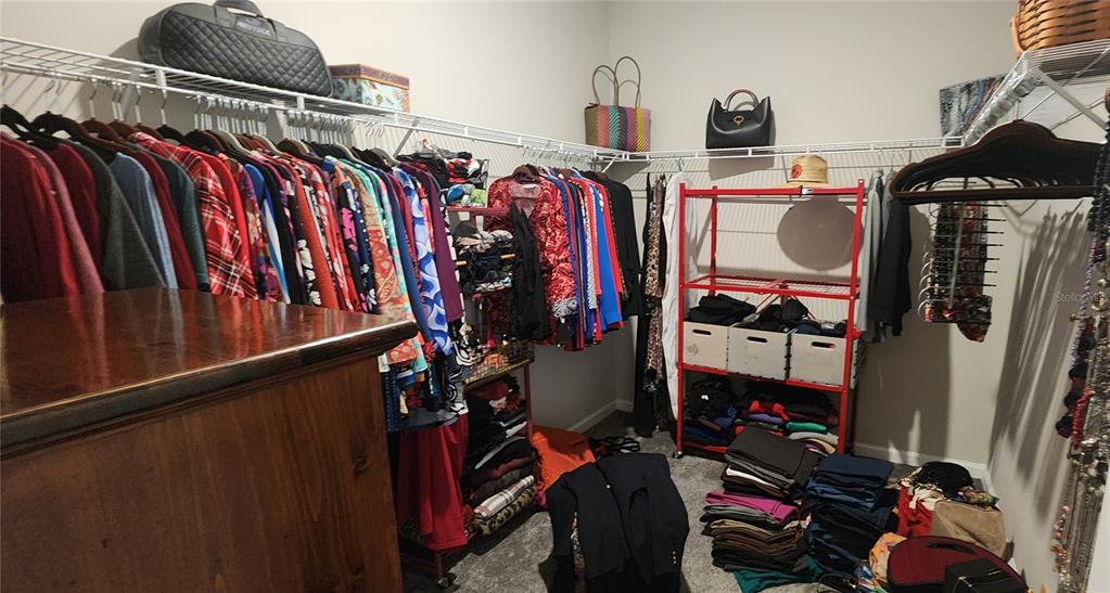 9032 Cape Cod Road DeLand, FL 32724 - Photo 15 of 16 a view of walk in closet with clothes and shoes