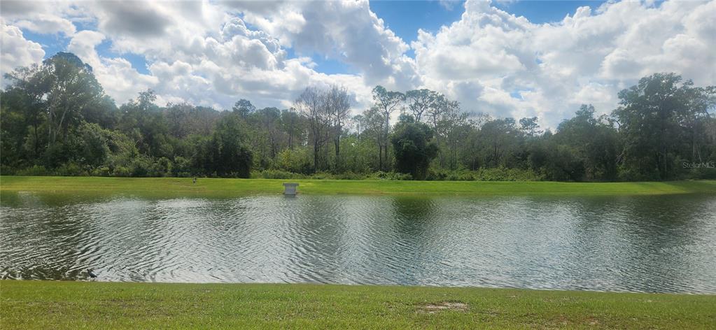9032 Cape Cod Road DeLand, FL 32724 - Photo 5 of 16 a view of a golf course with a lake