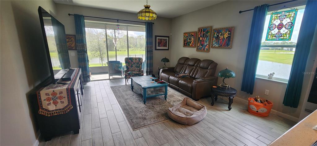 9032 Cape Cod Road DeLand, FL 32724 - Photo 7 of 16 a living room with furniture and a flat screen tv