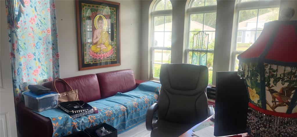 9032 Cape Cod Road DeLand, FL 32724 - Photo 8 of 16 a living room with furniture and a window