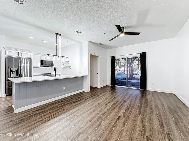 a large kitchen with stainless steel appliances kitchen island a large island in the center