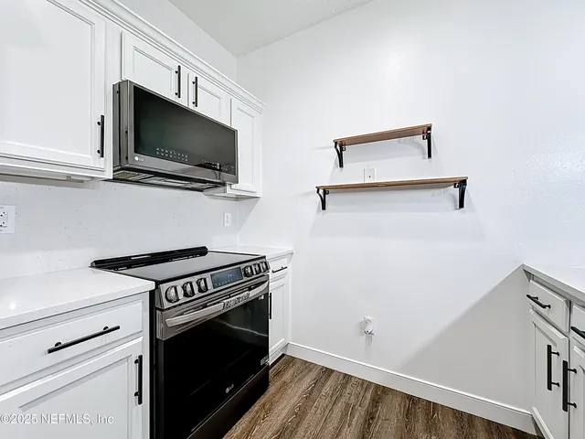 a kitchen with a stove and a microwave