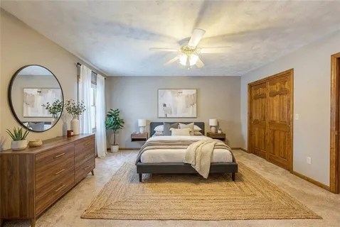 a bed room with a bed mirror and a window