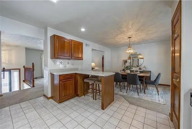 a open kitchen with cabinets table and chairs