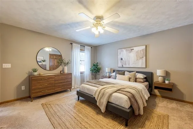 a bedroom with a bed a dresser and window