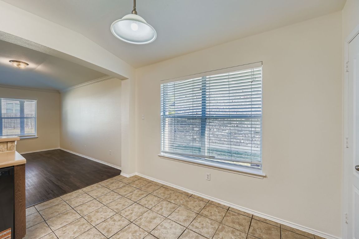 12612 Waynespur Lane Elgin, TX 78621 - Photo 11 of 22 a view of an empty room with wooden floor and a window