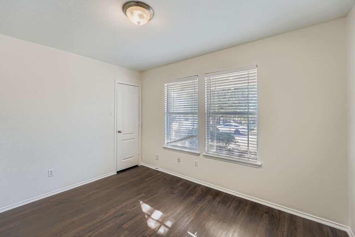 12612 Waynespur Lane Elgin, TX 78621 - Photo 14 of 22 a view of an empty room with wooden floor and a window