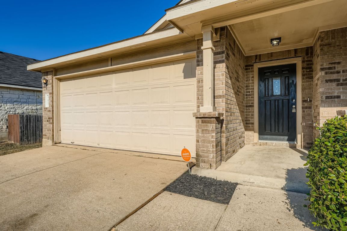 12612 Waynespur Lane Elgin, TX 78621 - Photo 2 of 22 a front view of a house with a garage